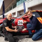 Porsche Carrera Cup Middle East race car on Gulf circuit featuring STARTRADER branding during the 2025/2026 racing season.